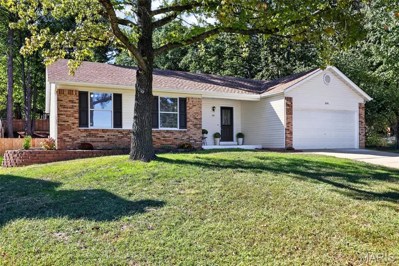 Charming brick ranch home situated on a mature, tree-lined lot with a spacious manicured lawn — 341 Westbrook Drive, O'Fallon, MO 63366