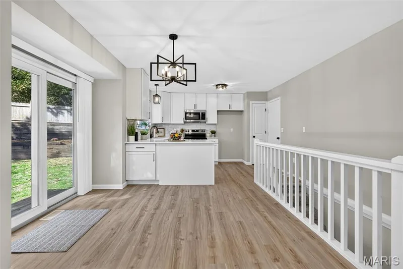 Kitchen with white cabinetry, stainless steel appliances, and a central island — 341 Westbrook Drive, O'Fallon, MO 63366