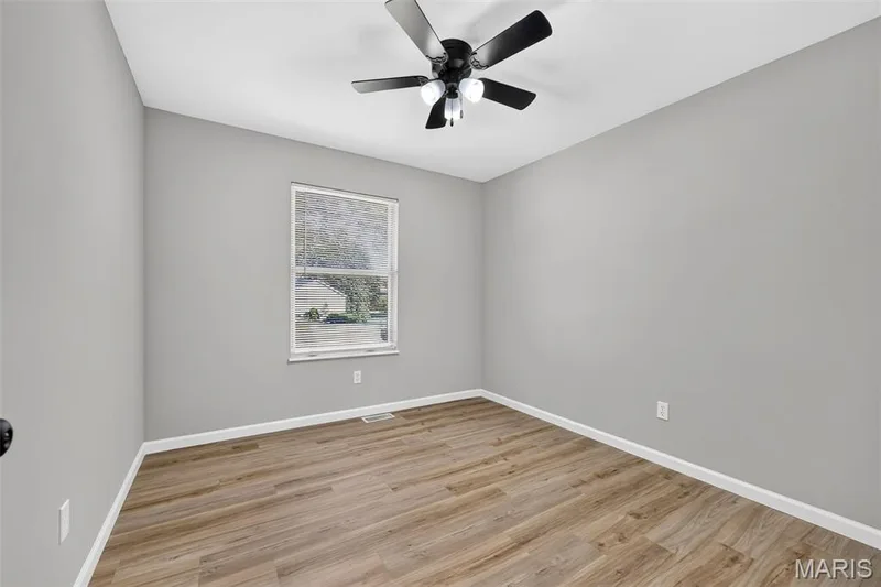 Wood-finish flooring, neutral gray walls, and a white trim — 341 Westbrook Drive, O'Fallon, MO 63366