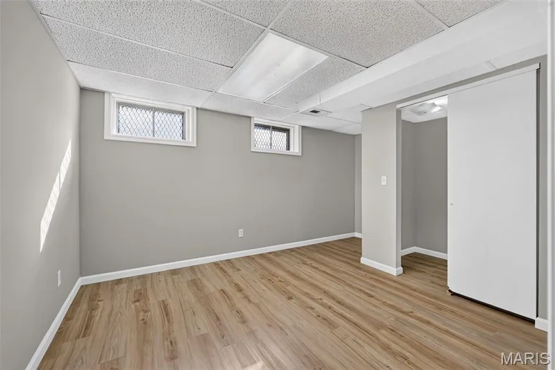 Wood-finish flooring, neutral wall paint, white trim, and recessed ceiling lighting — 341 Westbrook Drive, O'Fallon, MO 63366
