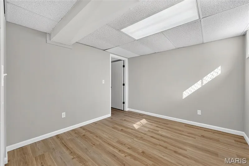 Wood-finish flooring with white trim and light gray walls — 341 Westbrook Drive, O'Fallon, MO 63366