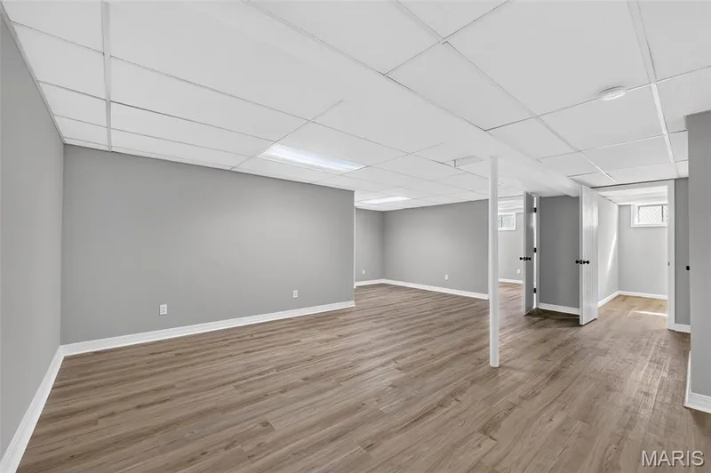 Expansive finished lower level featuring wood-finish flooring, recessed lighting, and light grey wall finishes — 341 Westbrook Drive, O'Fallon, MO 63366
