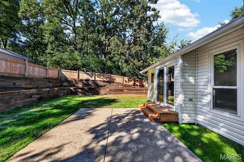 Patio with concrete surfacing and natural wood steps — 341 Westbrook Drive, O'Fallon, MO 63366