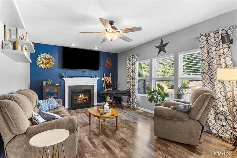 The Family Room has cozy gas fireplace as the focal point & a wall of windows bringing in all the natural light! — 2542 Amber Willow Court, Lake St. Louis, MO 63367