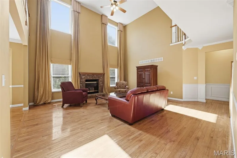 Window wall in 2-story great room, wood floors throughout. — 1615 Wainscott Court, O'Fallon, MO 63366