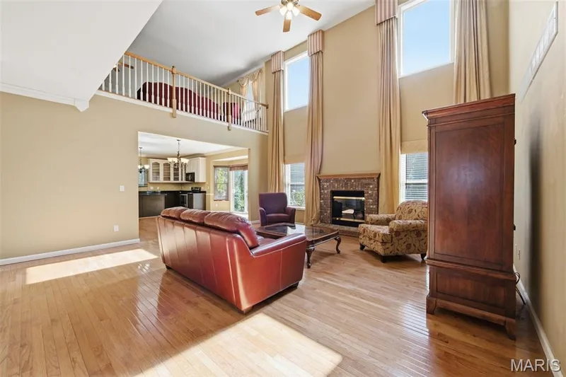 Great room with gas fireplace, window wall and 2nd floor loft. — 1615 Wainscott Court, O'Fallon, MO 63366