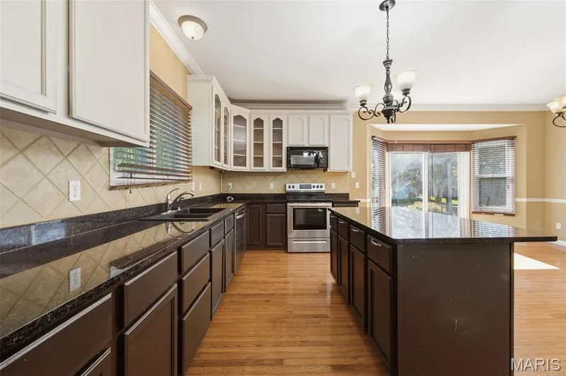 Stainless steel appliances, granite countertop and ceramic backsplash. — 1615 Wainscott Court, O'Fallon, MO 63366