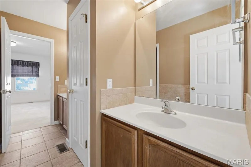 Another view of Jack and Jill bath with linen closet. — 1615 Wainscott Court, O'Fallon, MO 63366