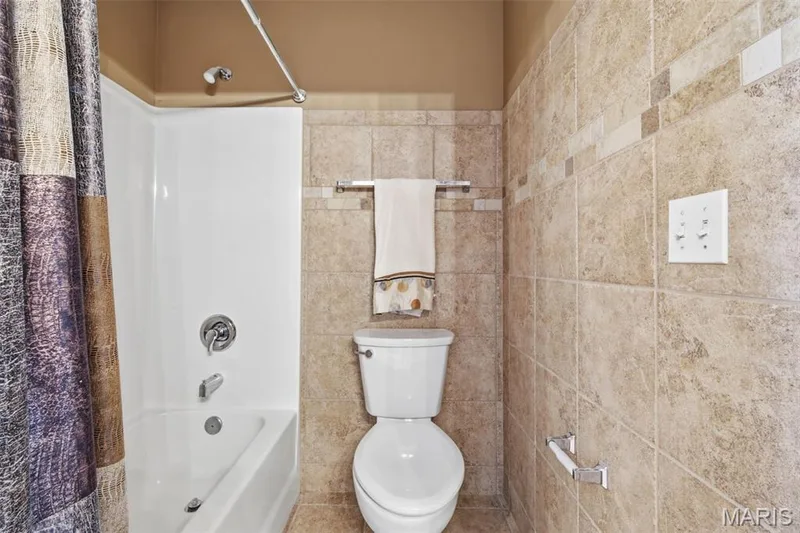 Jack and Jill shower and toilet with ceramic floor and walls. — 1615 Wainscott Court, O'Fallon, MO 63366