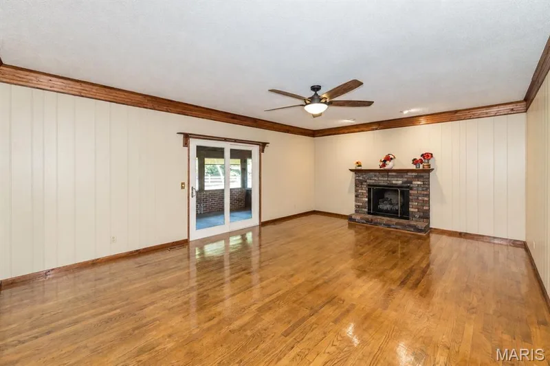 Family room features a cozy fireplace and access to the screened porch. — 357 Beaver Lake Drive, St Charles, MO 63303