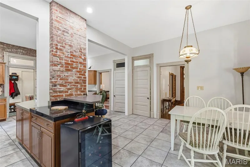 Exposed brick pillar, ceramic tile flooring, built-in cabinetry, polished stone countertops, and classic transom-topped doorways — 711 N 5th Street, St Charles, MO 63301