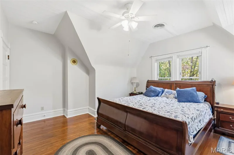 Vaulted ceilings with beadboard paneling, polished wood-finish flooring, and a central ceiling fan — 711 N 5th Street, St Charles, MO 63301