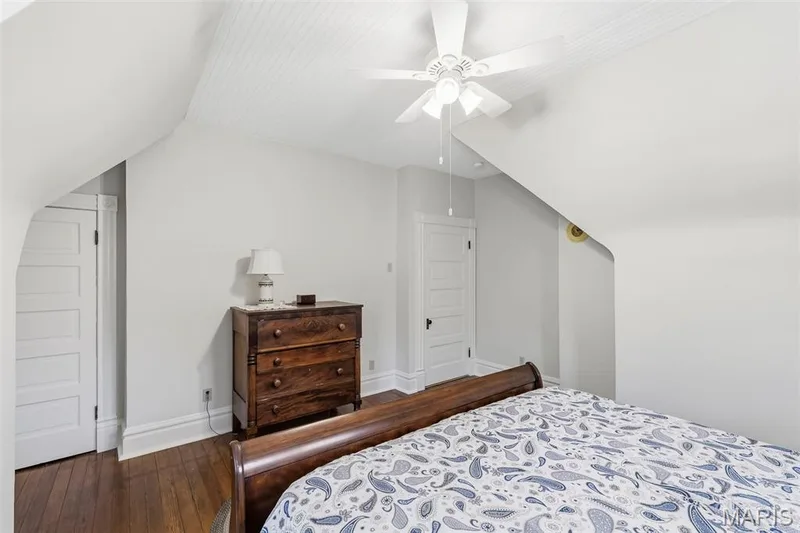 Vaulted ceiling with beadboard paneling, white five-panel interior doors, and polished wood flooring — 711 N 5th Street, St Charles, MO 63301