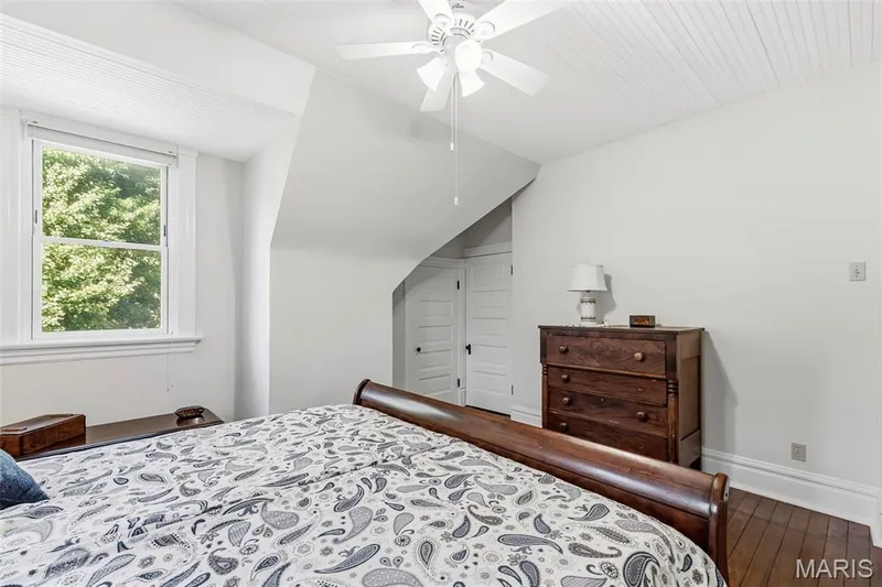 Beadboard ceiling, white-finished interior walls, wood-finish flooring, multi-pane window, and white four-panel interior doors — 711 N 5th Street, St Charles, MO 63301
