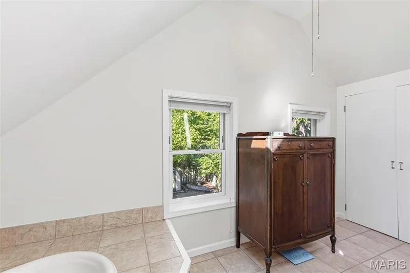 Vaulted ceilings, tiled surfaces, dual casement windows, and double-door closet storage — 711 N 5th Street, St Charles, MO 63301