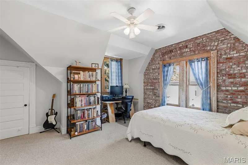 Exposed brick wall, vaulted beadboard ceiling, and white panel door — 711 N 5th Street, St Charles, MO 63301