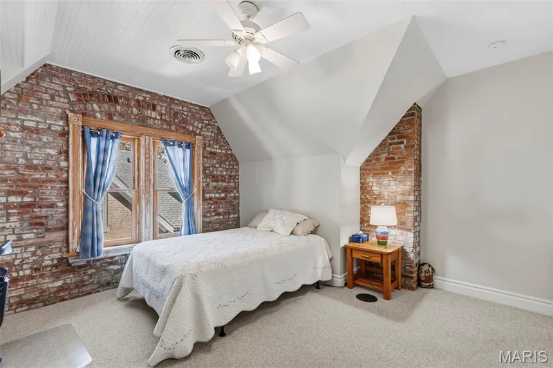 Exposed brick walls, wood-framed windows, beadboard-style ceiling, and overhead ceiling fan with integrated lighting — 711 N 5th Street, St Charles, MO 63301