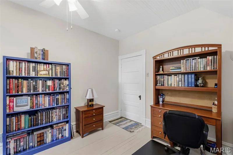 Vaulted ceiling with beadboard paneling, white painted wood flooring, and a five-panel interior door with period-style hardware — 711 N 5th Street, St Charles, MO 63301