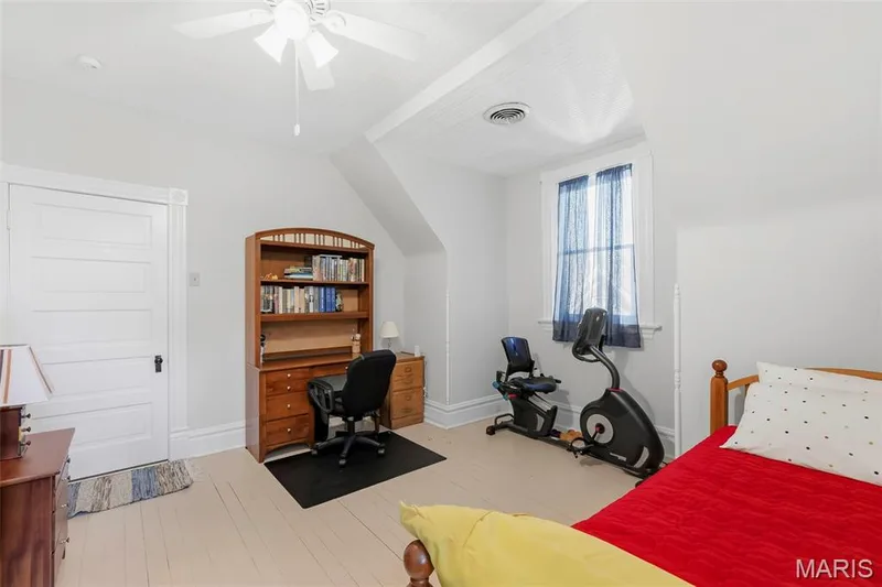 Room featuring white beadboard ceiling, wood-finish flooring, multi-pane window, and a white five-panel interior door — 711 N 5th Street, St Charles, MO 63301