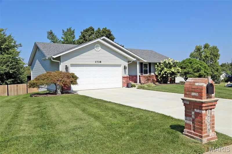 Ranch-style residence featuring light-colored siding and a grey shingle roof — 1738 Sun Drop Drive, St Charles, MO 63303