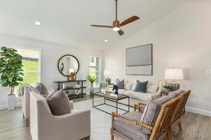 Living room featuring light hardwood / wood-style flooring, ceiling fan, and high vaulted ceiling — 2 Hickory at Elm Crossing, St Charles, MO 63301