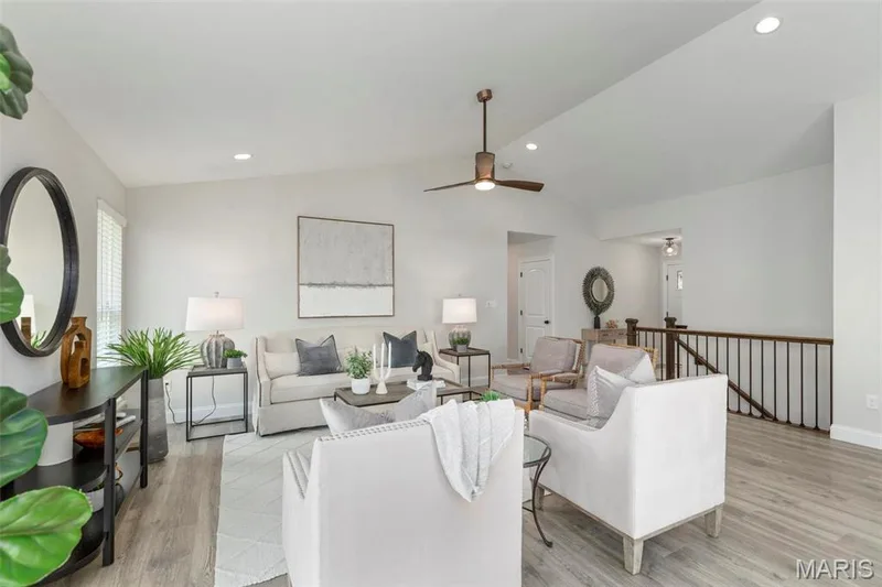 Living room with light wood-type flooring, vaulted ceiling, and ceiling fan — 2 Hickory at Elm Crossing, St Charles, MO 63301
