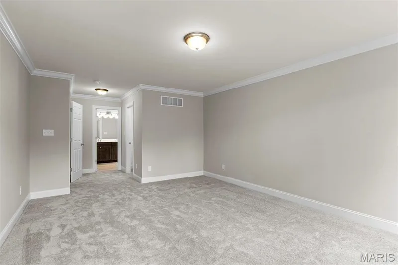 Carpeted spare room with crown molding — 2 Maple at Elm Crossing, St Charles, MO 63301