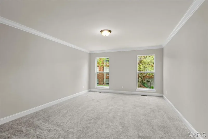 Empty room with carpet floors and ornamental molding — 2 Maple at Elm Crossing, St Charles, MO 63301