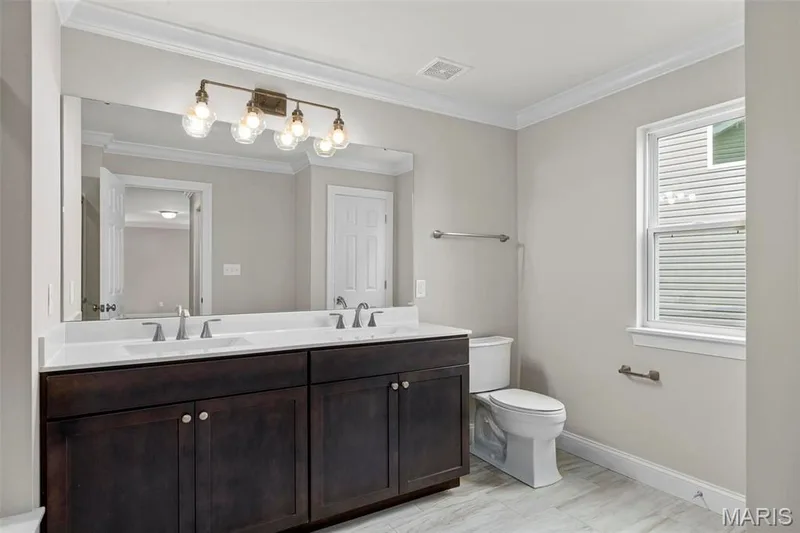 Bathroom with ornamental molding, vanity, and toilet — 2 Maple at Elm Crossing, St Charles, MO 63301