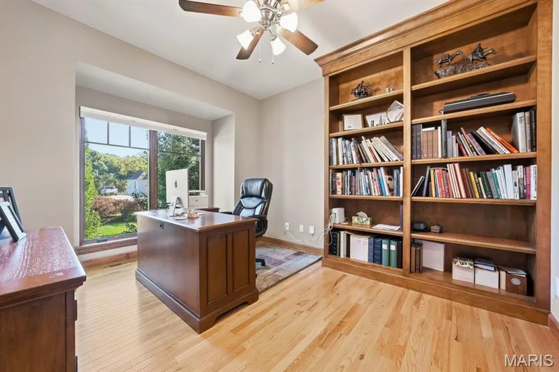 The den offers built in bookshelf, ceiling fan and wood floors — 117 Trail Creek Court, St Charles, MO 63304