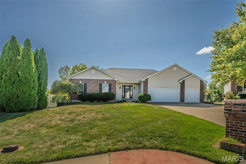 The building site features a level front lawn area and a large fenced rear yard that would be perfect for a pool.  A newer deck overlooks the yard and patio from the full walkout terrace level. — 84 Reuben Court, O'Fallon, MO 63376