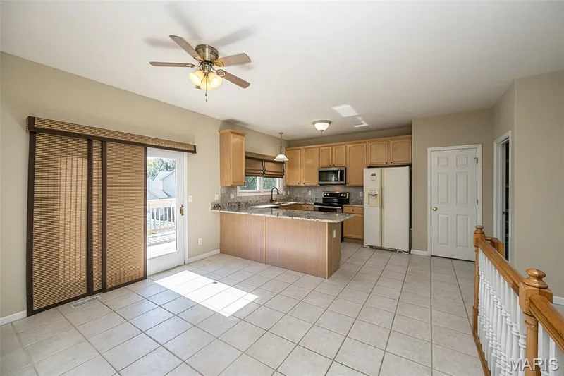 The Kitchen and the Dining area spans 25 feet.  Custom window treatments. — 84 Reuben Court, O'Fallon, MO 63376