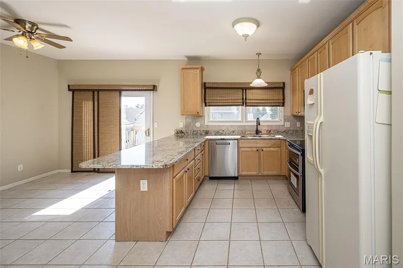 The newer patio door leads to the entertainment deck overlooking the rear yard. — 84 Reuben Court, O'Fallon, MO 63376