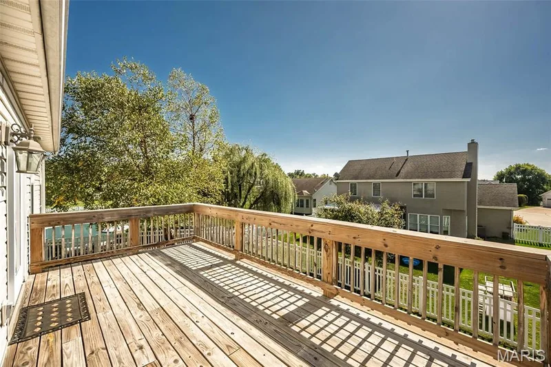 A view of the deck and a hint of the fenced rear yard. — 84 Reuben Court, O'Fallon, MO 63376