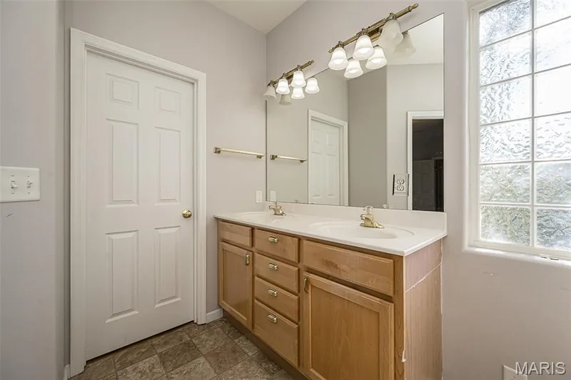 The prep area of the Primary Bath with privacy glass offering natural lighting to the space and two prep stations for the owners. — 84 Reuben Court, O'Fallon, MO 63376