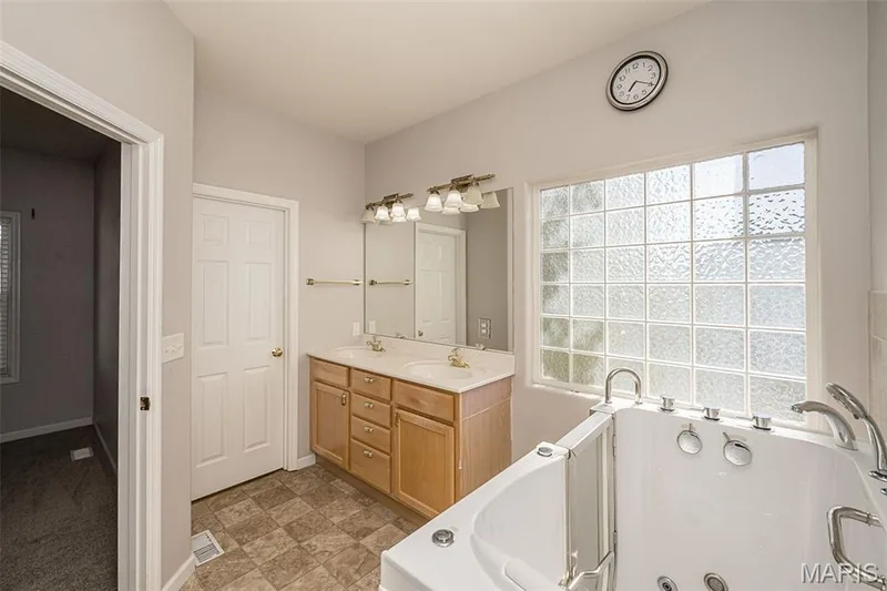Another photo of the primary bath.  The closed door is to the Primary Suite's closet. — 84 Reuben Court, O'Fallon, MO 63376