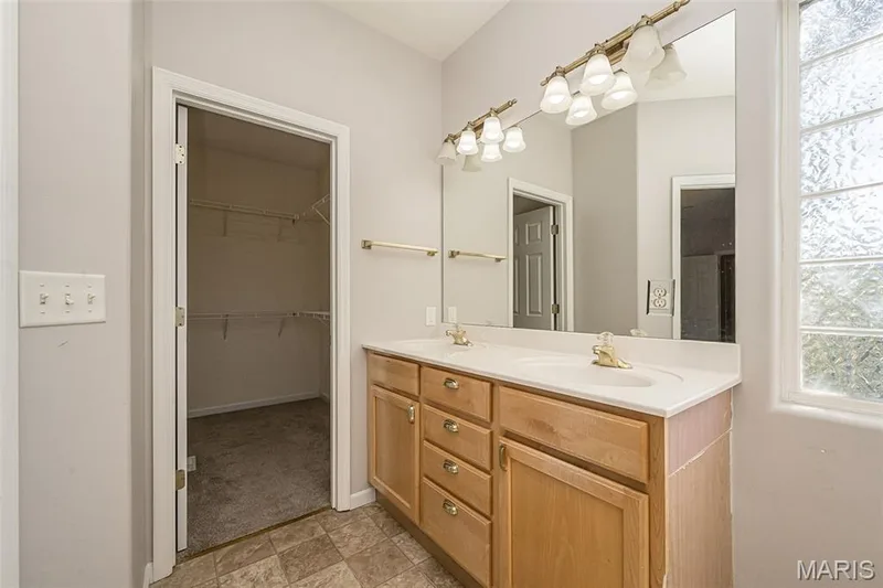 The open door allows a view of the primary closet. — 84 Reuben Court, O'Fallon, MO 63376