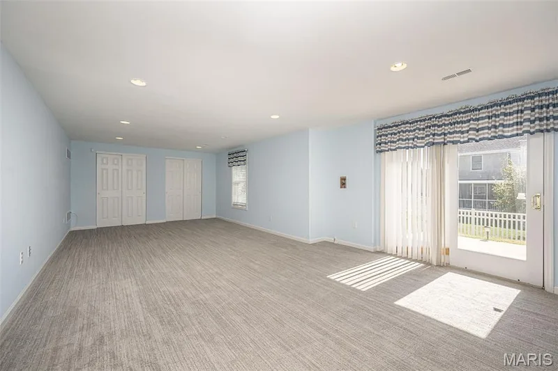 Welcome to the Terrace level Family Room.  The room spans 30 feet.  With the 2 double closet, the rear portion could be partitioned for a fifth private Bedroom. — 84 Reuben Court, O'Fallon, MO 63376