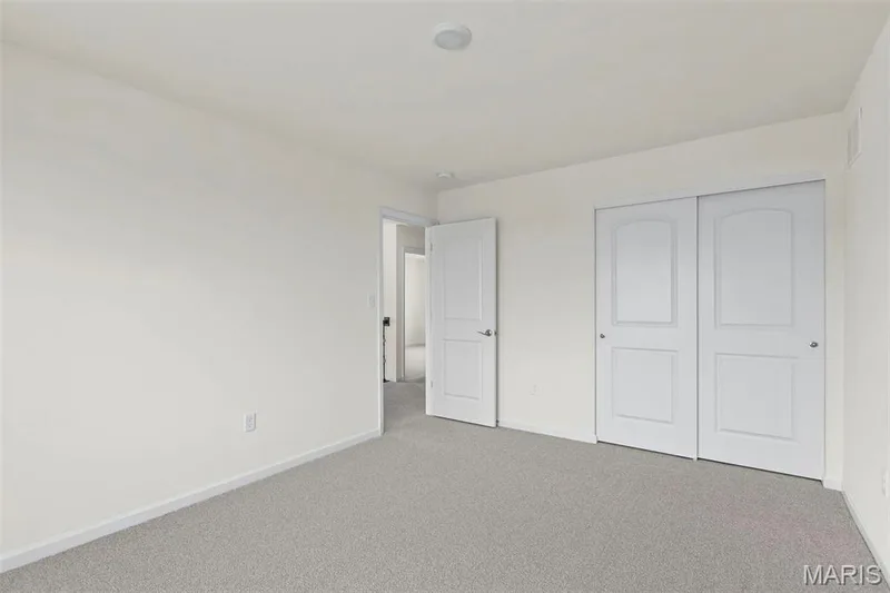 Unfurnished bedroom with carpet floors and a closet — 2 Sequoia at Elm Crossing, St Charles, MO 63301