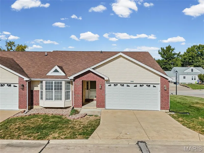 Brick and siding exterior with a two-car garage, front entry porch, and bay window — 2006 Chapel Hill Crossing, St Peters, MO 63376