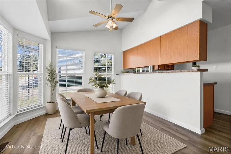 Vaulted ceiling, ceiling fan light fixture, wood-finish flooring, bay window with multiple windows, wood-finish upper cabinetry — 2006 Chapel Hill Crossing, St Peters, MO 63376