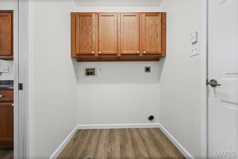 Wood-finish flooring, overhead cabinetry, and light-toned walls — 2006 Chapel Hill Crossing, St Peters, MO 63376