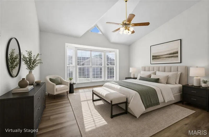 Vaulted ceiling with skylight, bay window, wood-finish flooring, and ceiling fan — 2006 Chapel Hill Crossing, St Peters, MO 63376