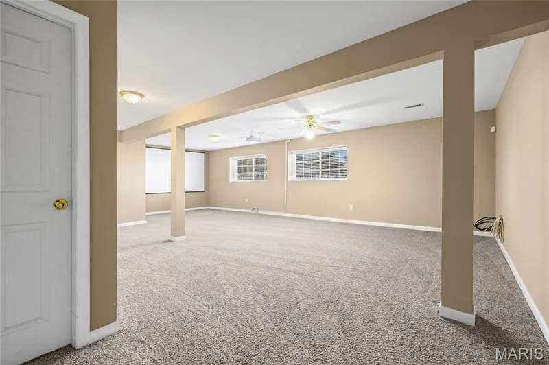 Spacious room featuring neutral carpeting, recessed lighting, multiple windows, and a ceiling fan — 2006 Chapel Hill Crossing, St Peters, MO 63376