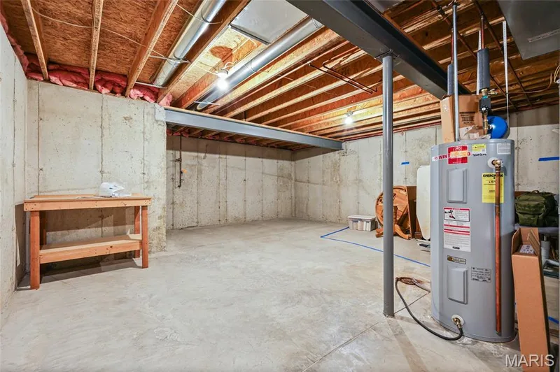 Unfinished basement featuring exposed joists, concrete walls, and a water heater — 2006 Chapel Hill Crossing, St Peters, MO 63376