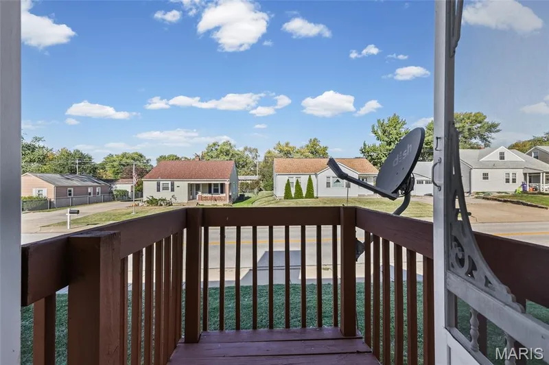 Front porch featuring wooden railing and flooring — 2006 Chapel Hill Crossing, St Peters, MO 63376