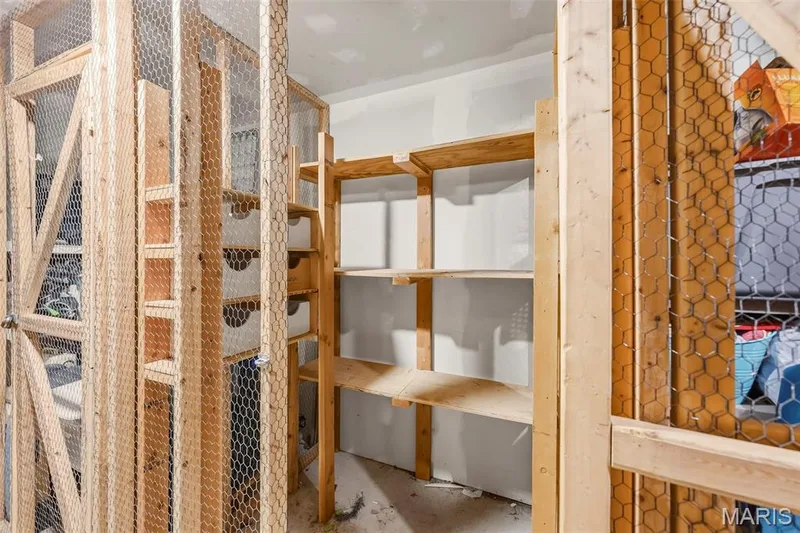 Built-in shelving with wood construction and wire mesh panels — 1410 Heritage Landing #106, St Charles, MO 63303