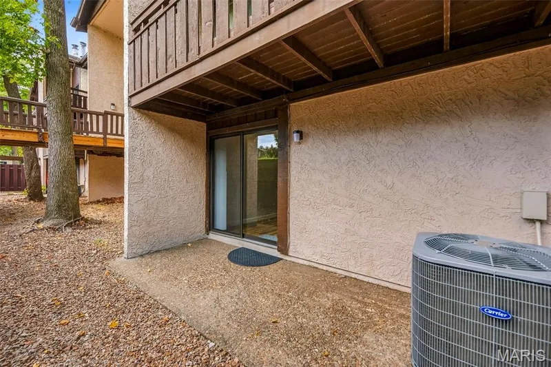 Ground-level patio with sliding glass door access — 1410 Heritage Landing #106, St Charles, MO 63303