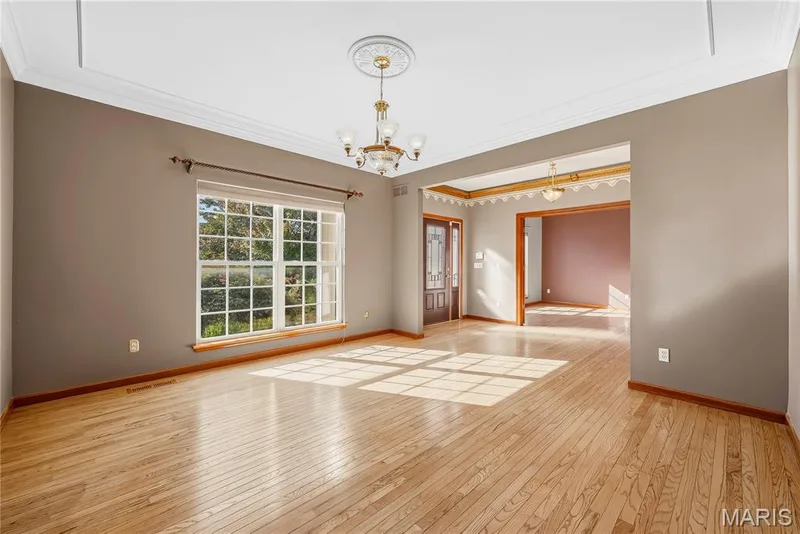 Formal dining room with gleaming hardwood floors — 28 Wolverton Court, St Charles, MO 63301