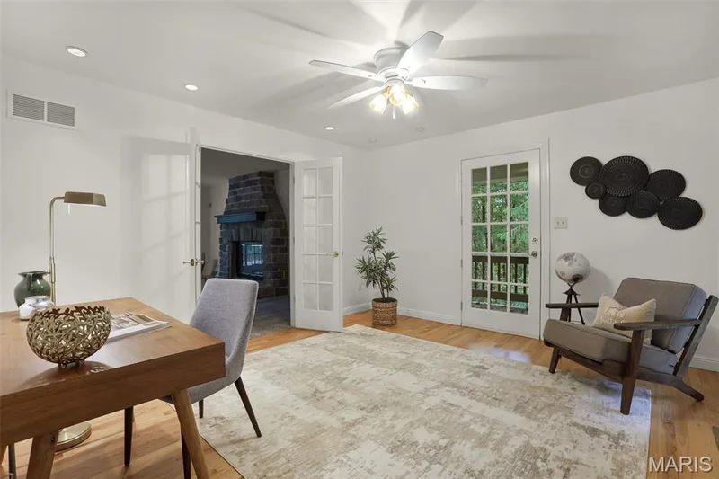 Room featuring wood-finish flooring, recessed lighting, a ceiling fan with integrated light fixture, a glass-paneled exterior door, and French doors — 229 Quail Run Drive, Defiance, MO 63341